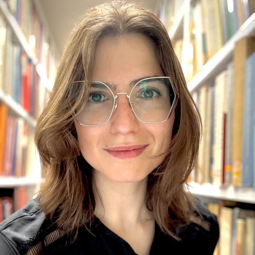 Connie Scozzaro standing in the library stacks